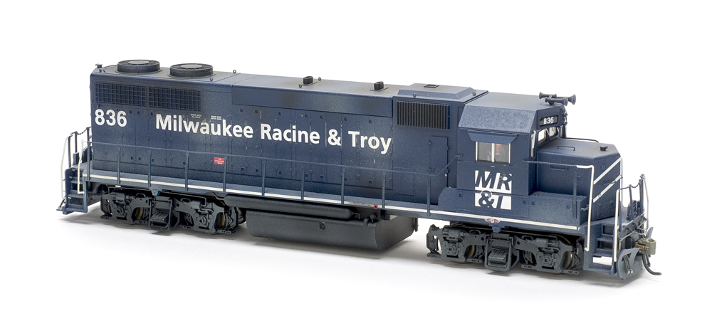 Photo of painted and weathered dark blue road locomotive on white background