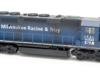 Photo of weathered dark blue six-axle road unit on white background