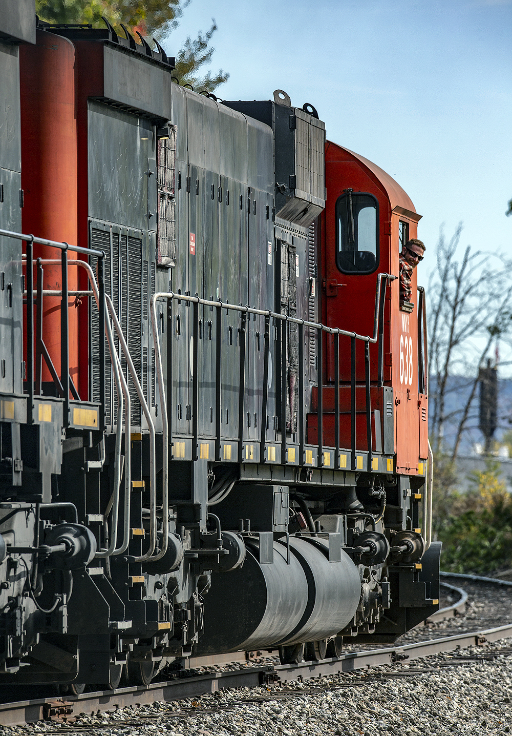 Image of parting locomotives with an engineer looking back at the photographer.