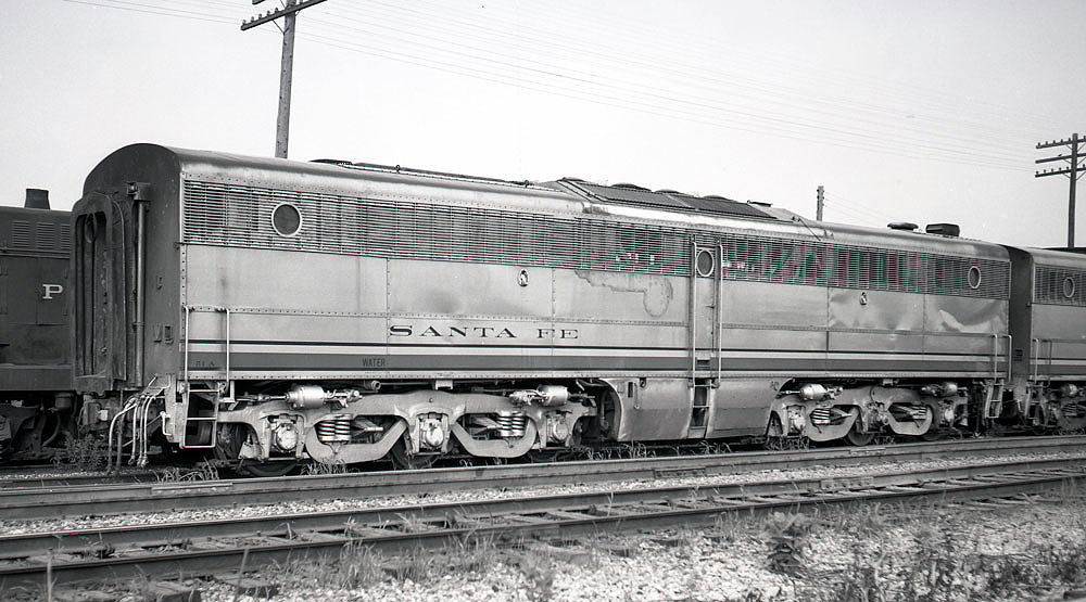 Black-and-white image of the side of a cab-less locomotive.