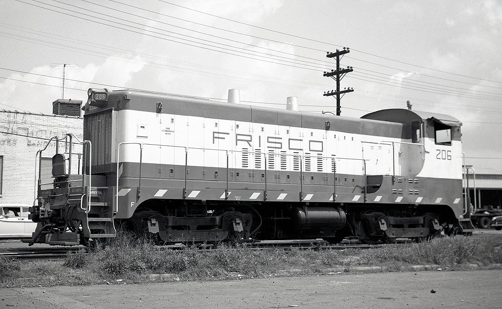 Black-and-white image of an end cab switching locomotive.
