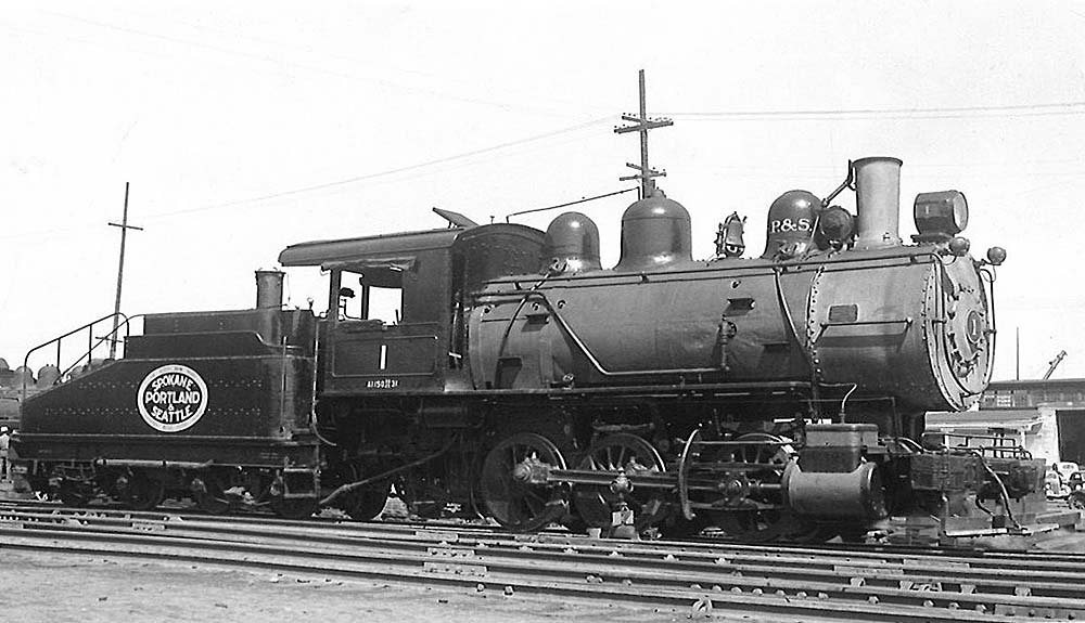 Steam locomotive with slope-back tender in profile