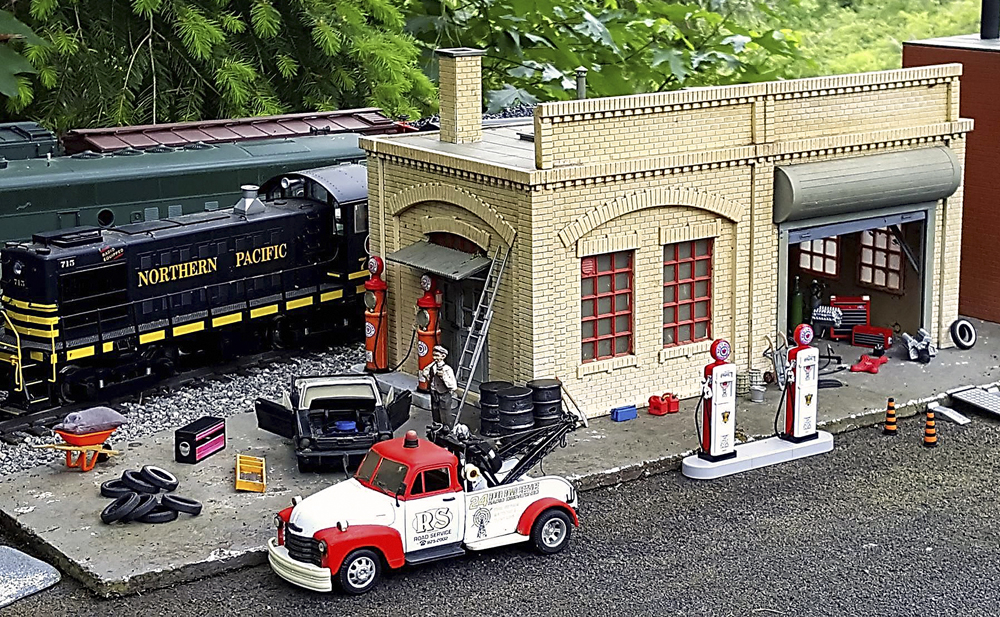Model gas station with truck and locomotive