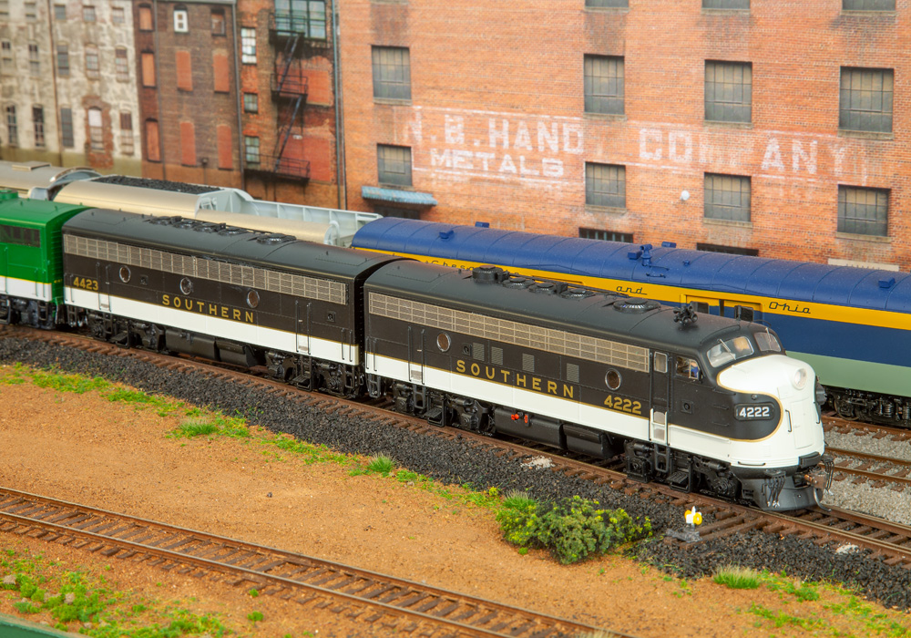 Green locomotives on a model train layout.