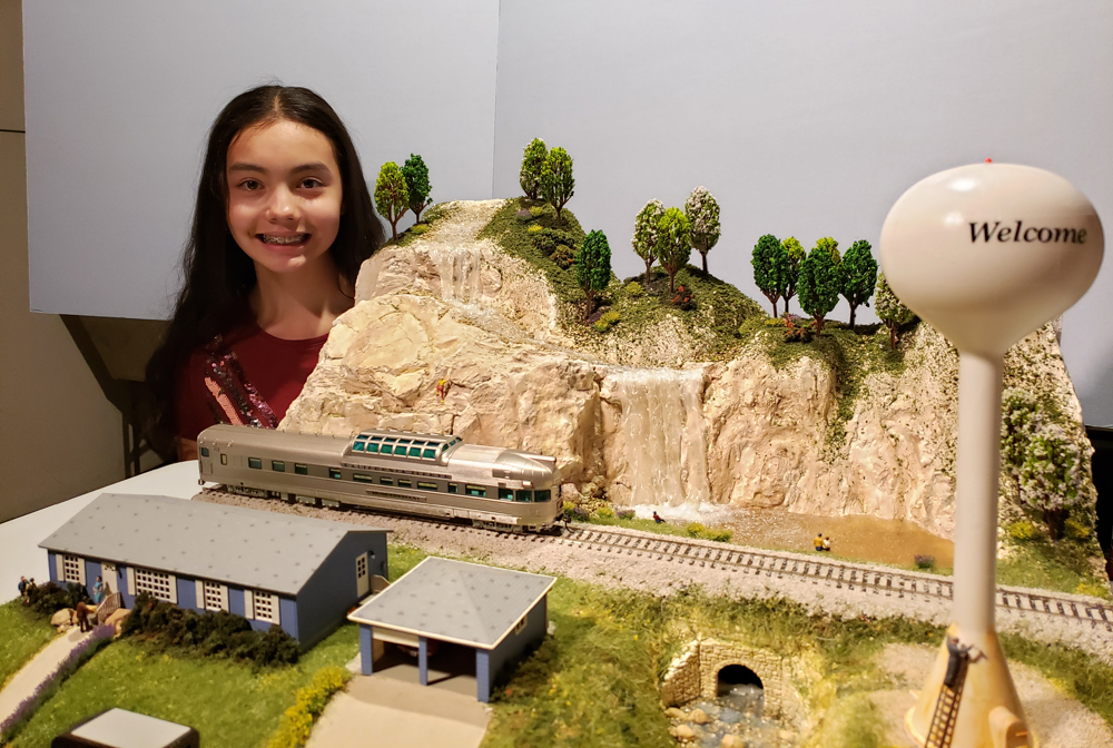 girl standing by her layout