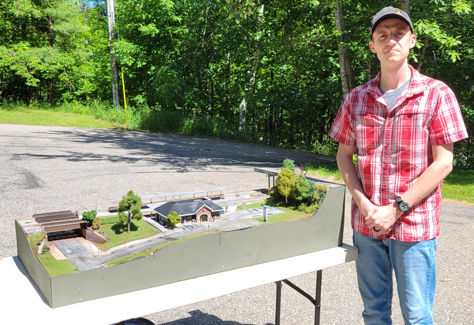 guy standing by his layout