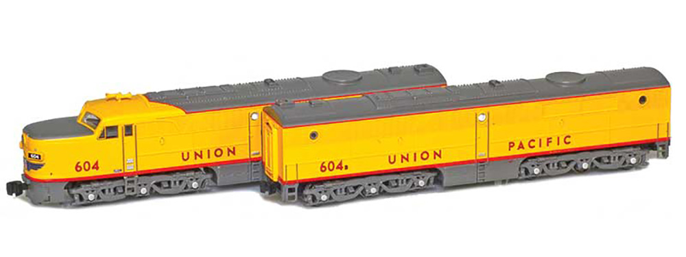 Two yellow train locomotives
