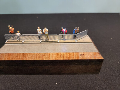 Pedestrian barriers and photographers with working camera flash in HO scale
