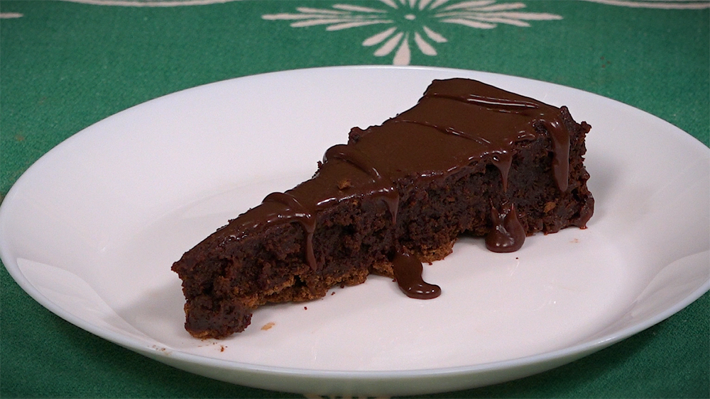 One piece of flourless chocolate torte on a white plate