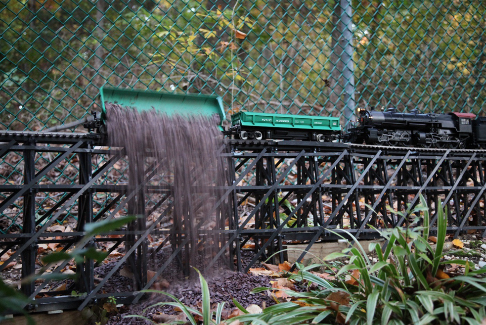 load of gravel being dumped on garden railway