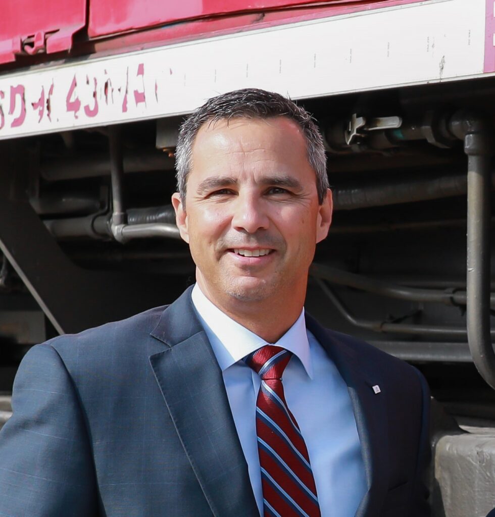 Man standing in front of locomotive