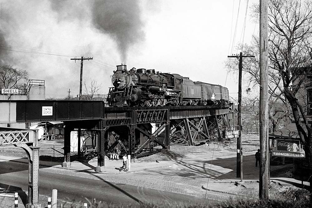 Central of Georgia steam locomotive on bridge in city