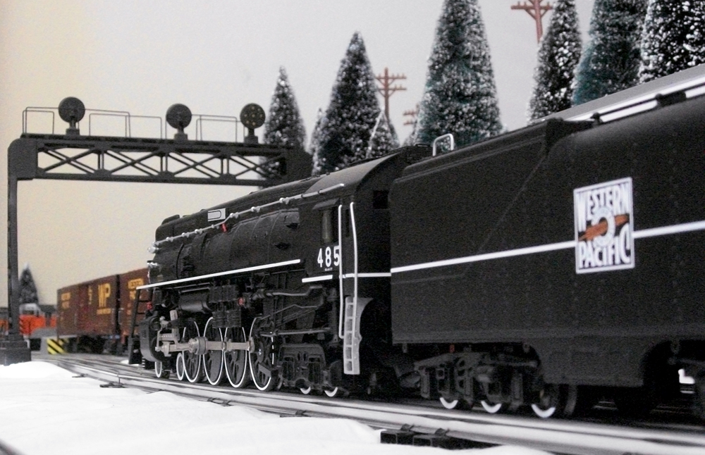 close up of model steam engine with trees