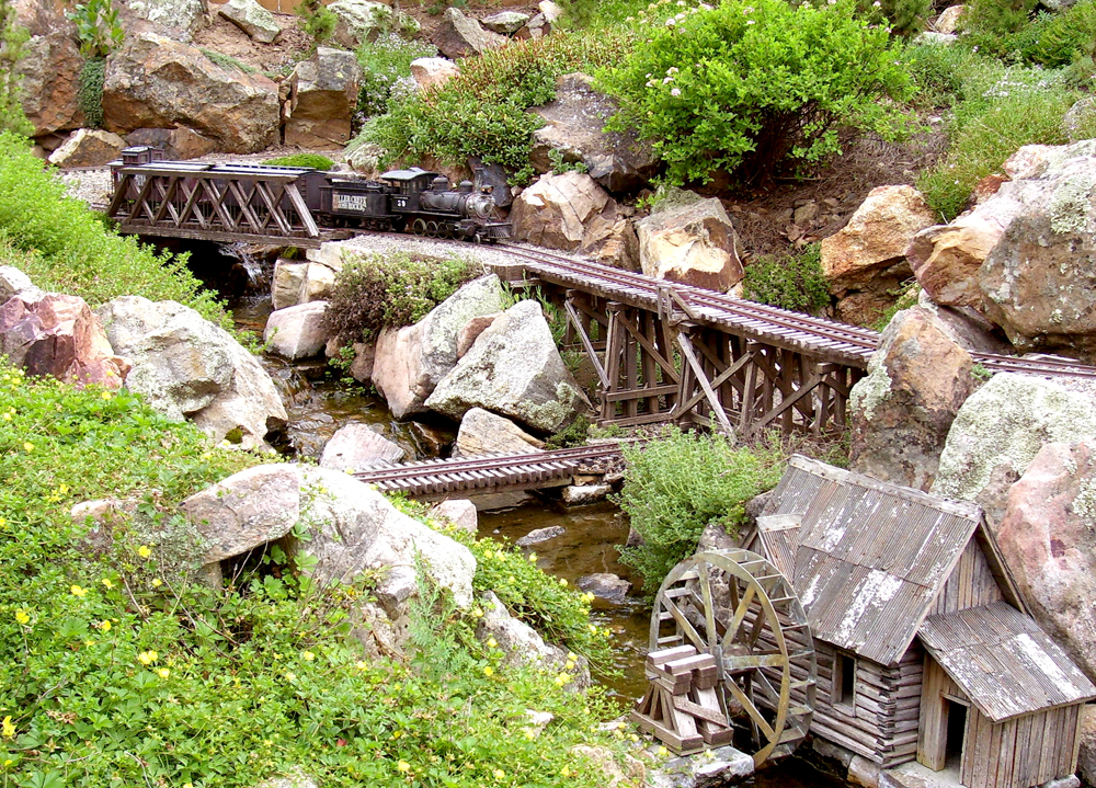 model steam engine on bridge in garden railway