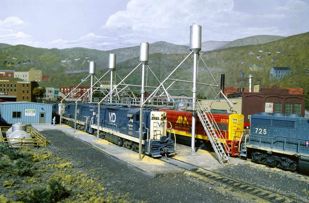 Diesel locomotives at a locomotive servicing terminal with four sand towers
