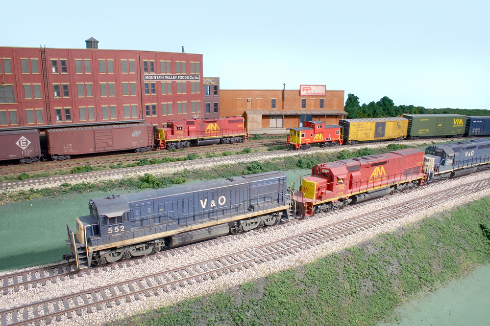 Photo of three HO scale trains passing each other