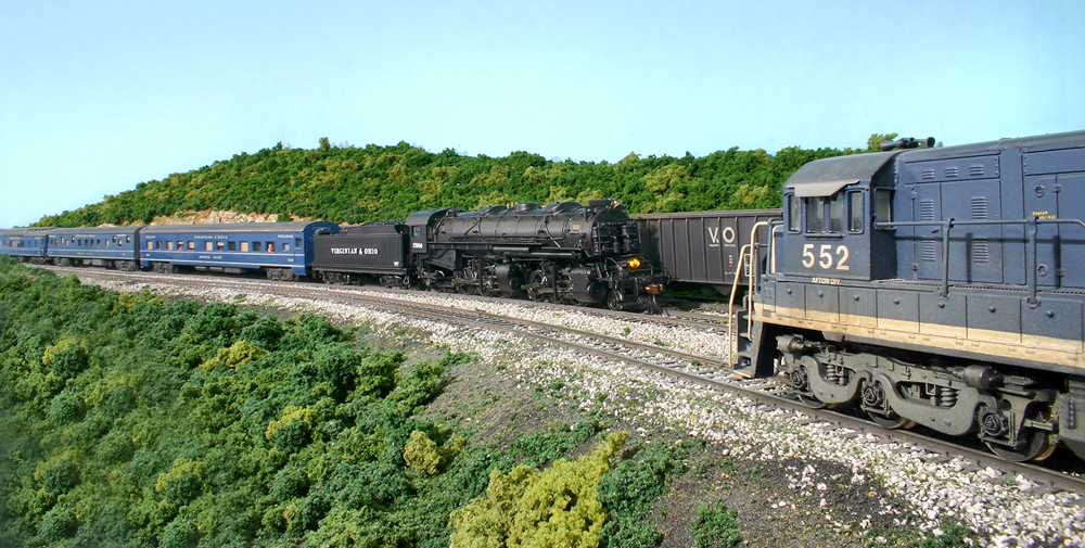 Steam powered business train meets freight train