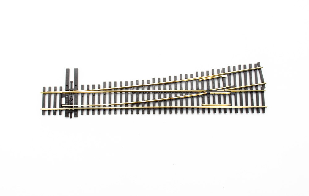 Photo of HO scale No. 6 left-hand turnout on white background.