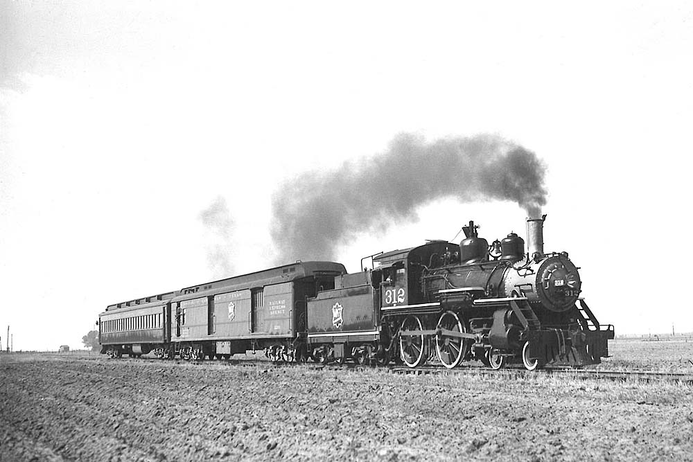 Steam Missouri-Kansas-Texas locomotive with two-car passenger train