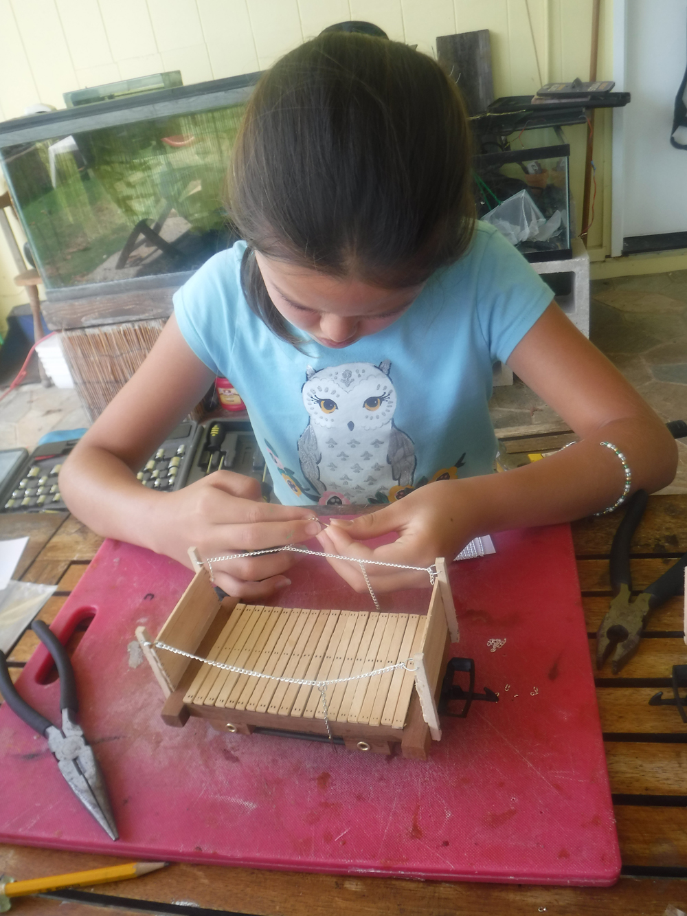 girl building wooden rolling stock