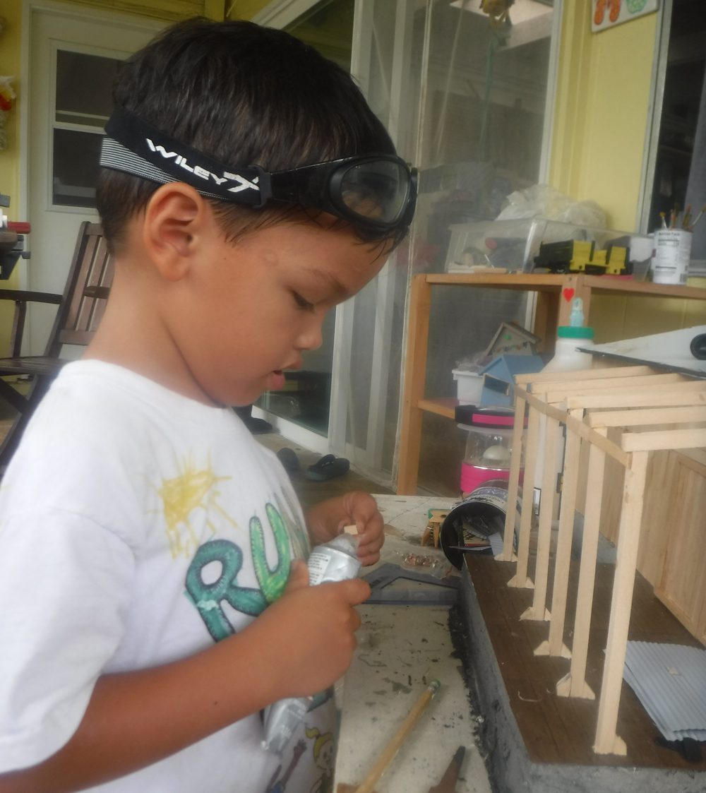 boy working with foam and craft sticks