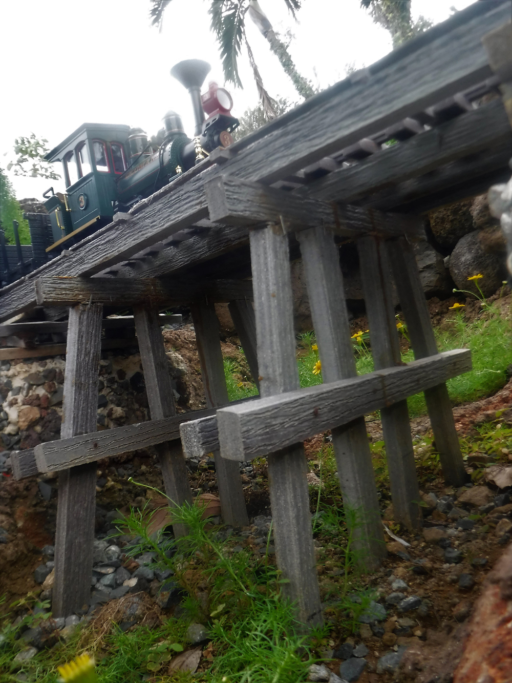 model steam engine crossing wood trestle