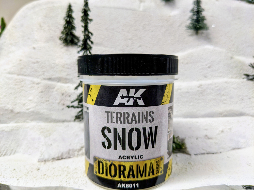 A white and black bottle on snowy scenery base
