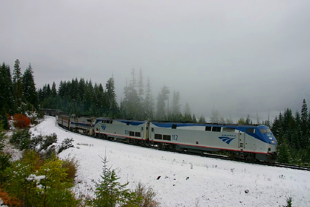 train in blizzard by mountains