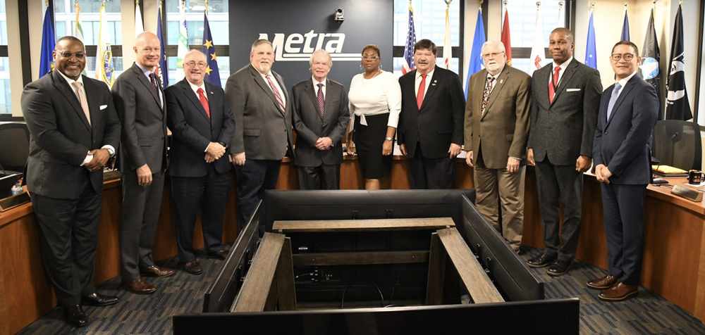 10 people posed in boardroom