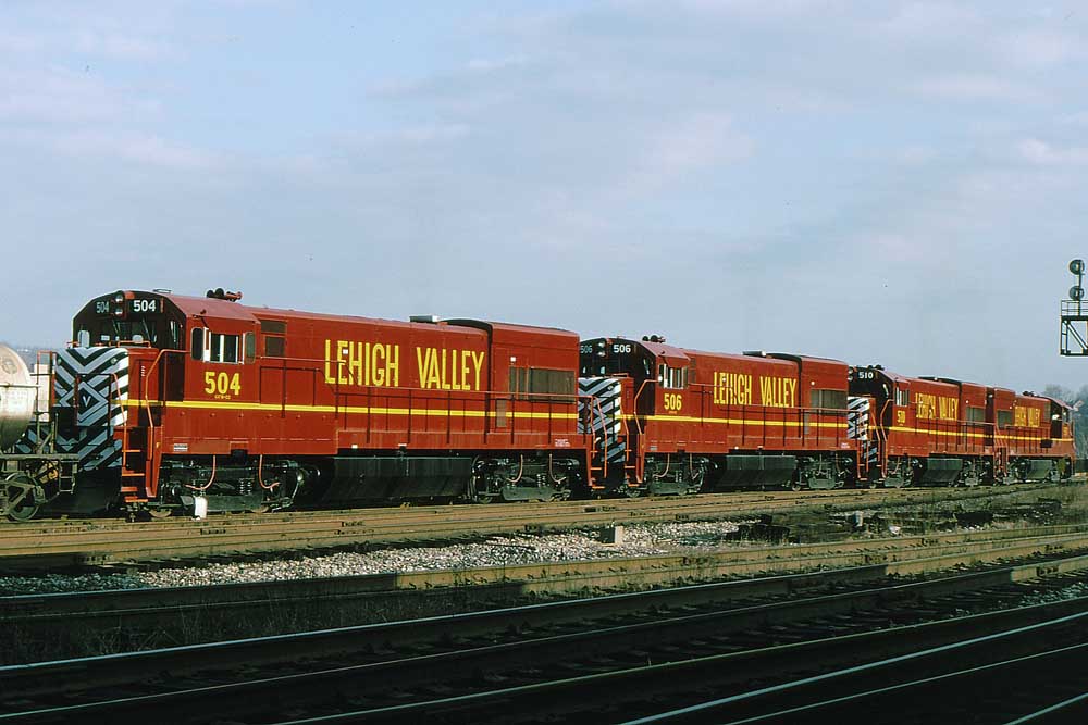 Four shiny new red-and-yellow diesel locomotives