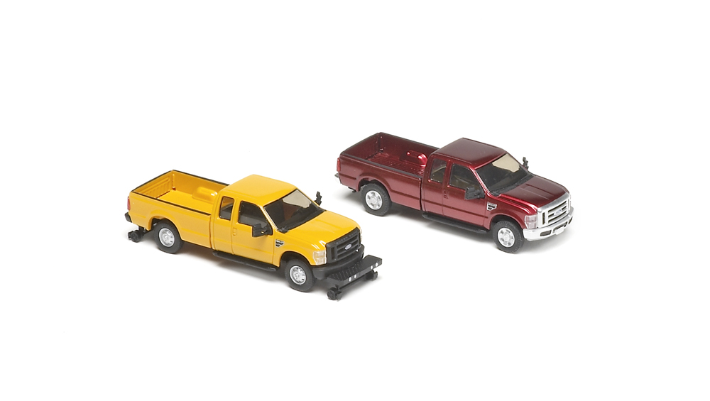Models of yellow and red pickup trucks