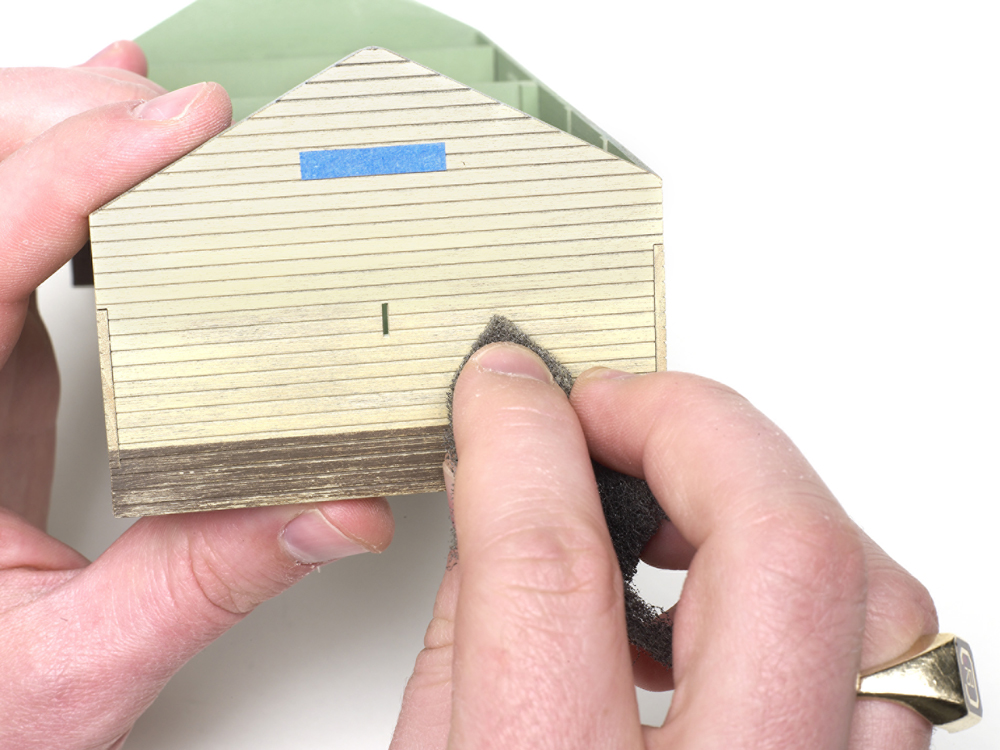 A weathering pad is used along the side of a wood structure.