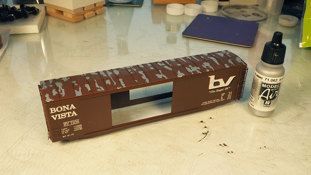 Car Swap Project part 7: Gerry’s creative touch: Brown model boxcar shell with silver paint patches on roof