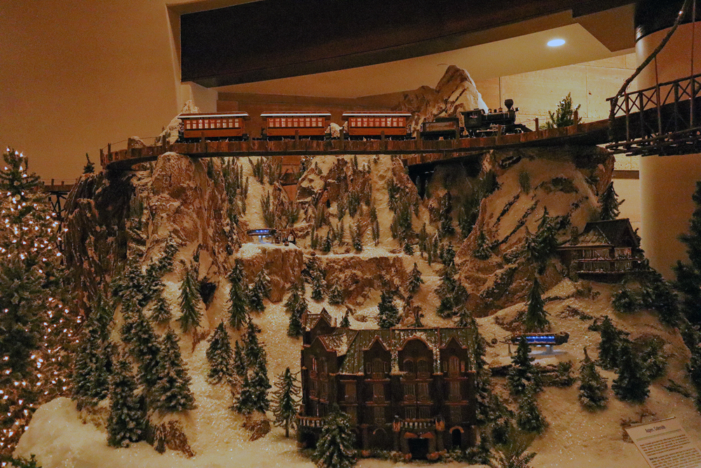 A steam train above a snowy mountain scene