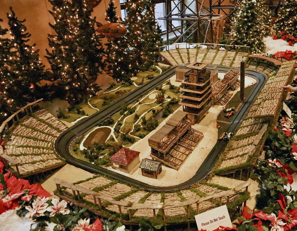 A slot car racetrack with grandstands and mini golf course