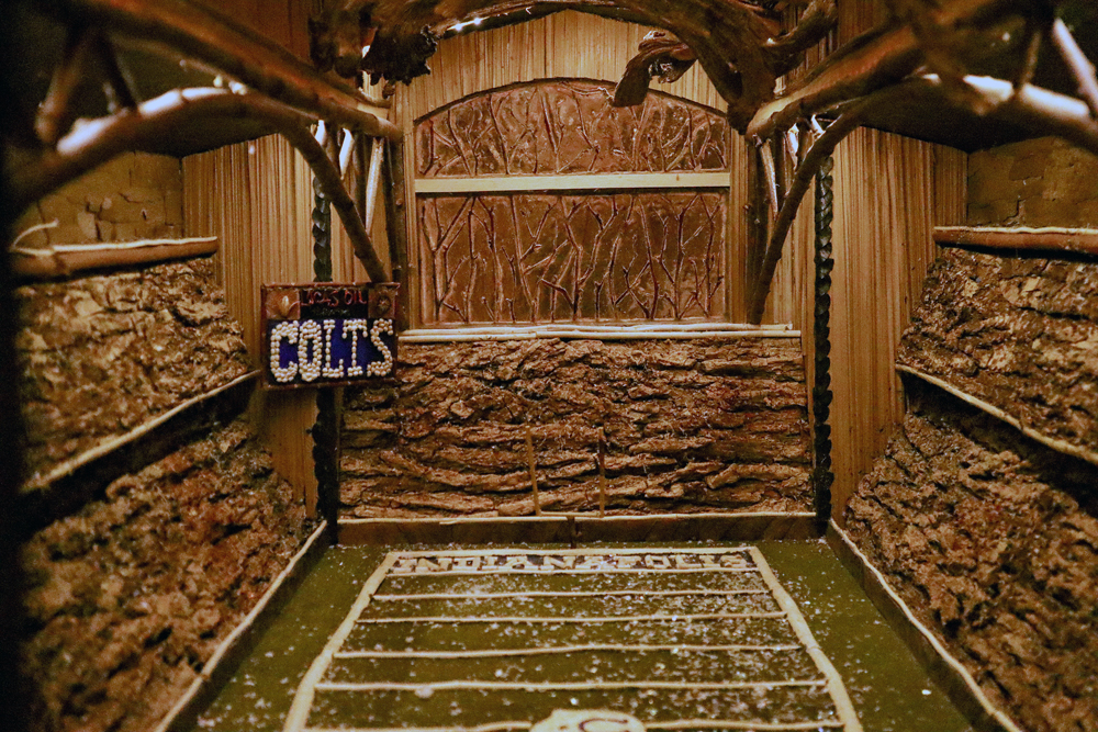 An indoor football field covered in fake snow