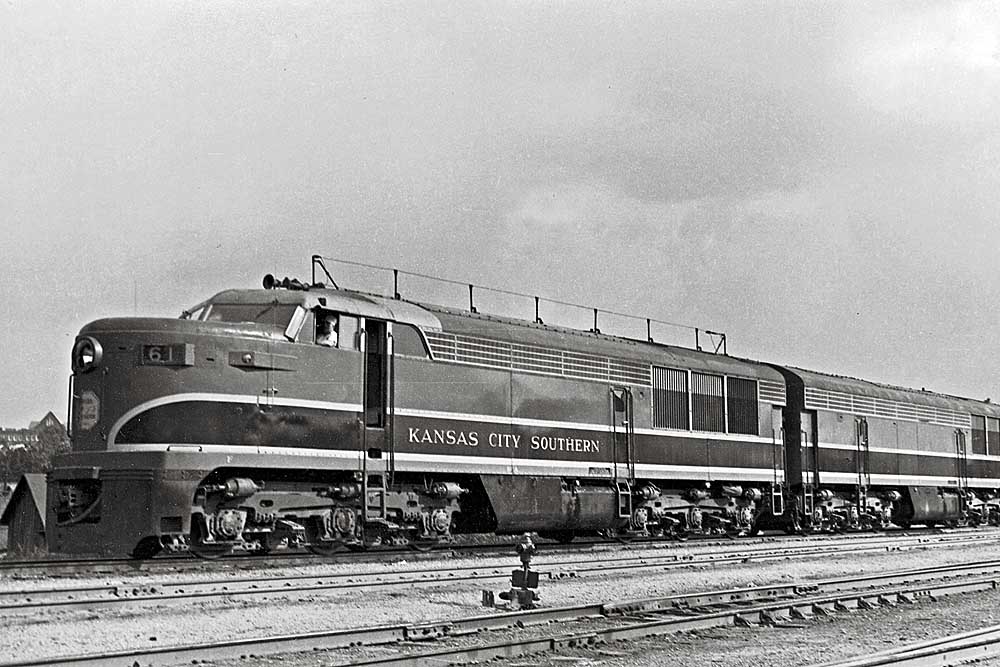 Three quarter view of diesel-powered Kansas City Southern locomotives in yard