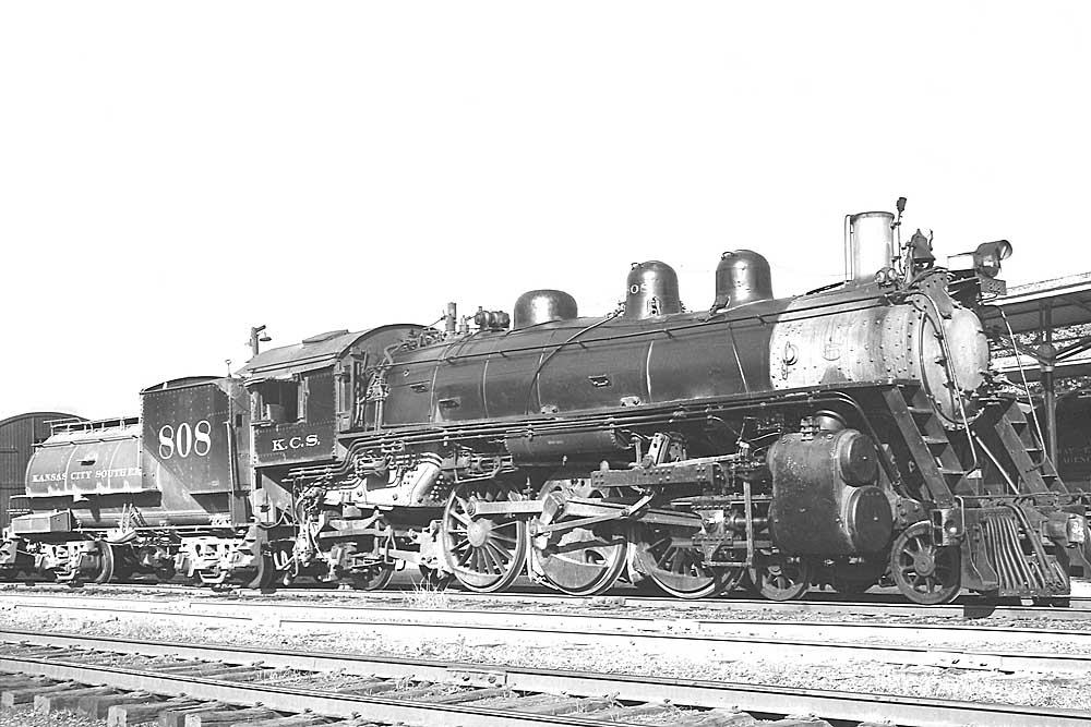 Three quarter front view of steam locomotive in yard