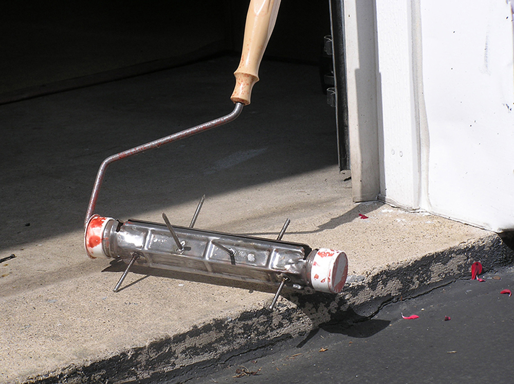paint rolling tool with nails attached