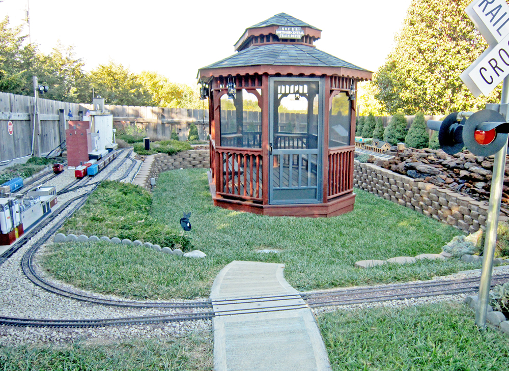 gazebo in the middle of a backyard garden railway