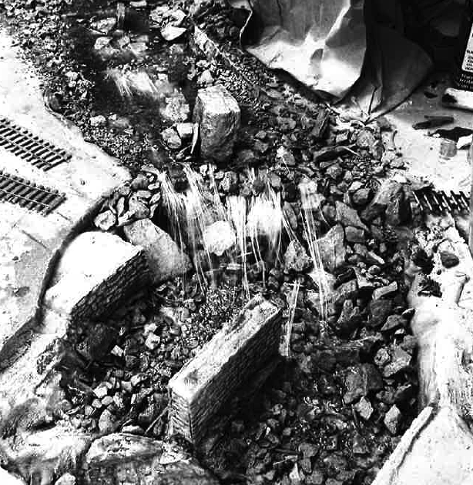 Malcolm Furlow's waterfall modeling technique: Thin strands of plastic filament glued to assorted rocks in a model riverbed