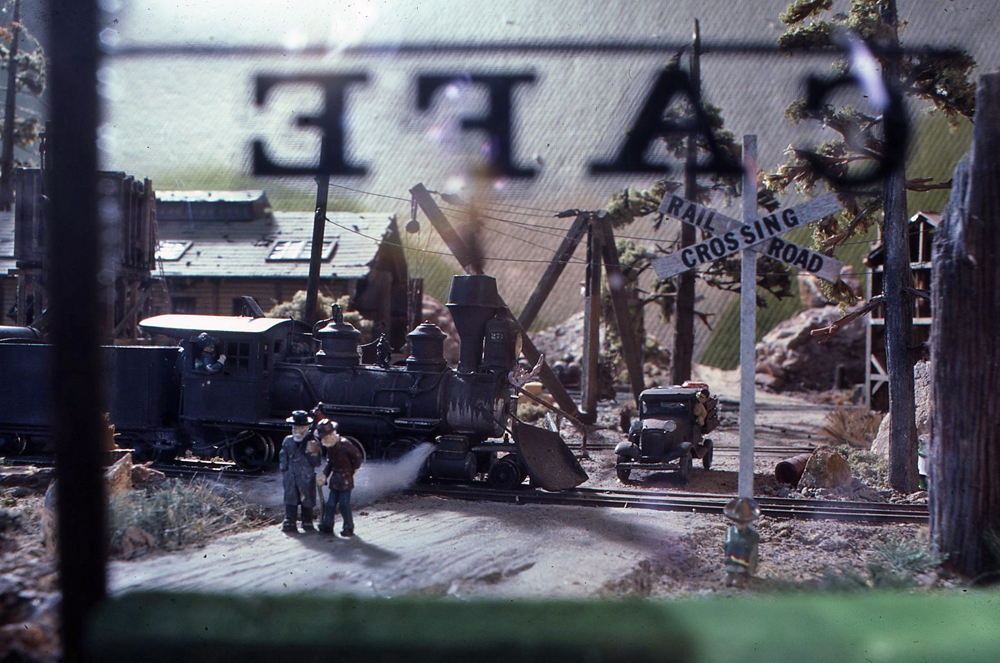 Color photo of model steam locomotive through cafe window