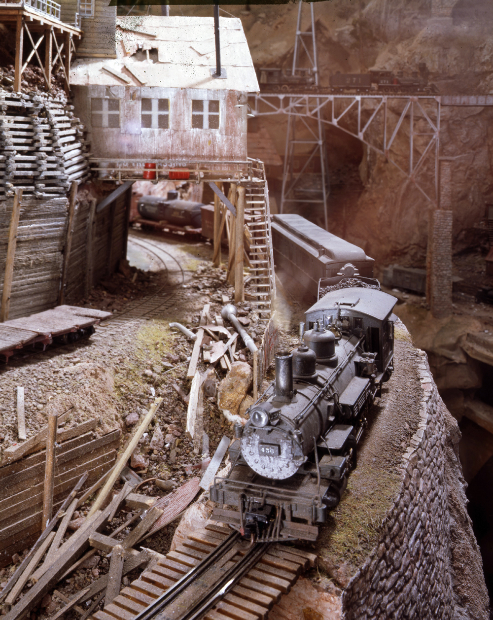 Color photo of steam locomotive on model railroad.