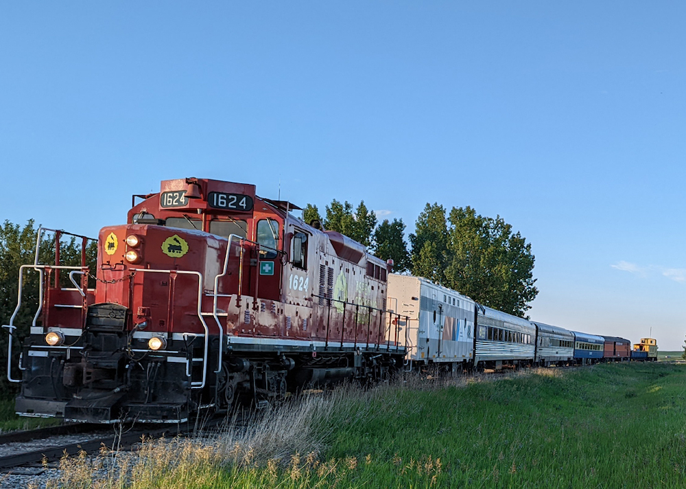 Diesel-powered excursion train rounding a curve.