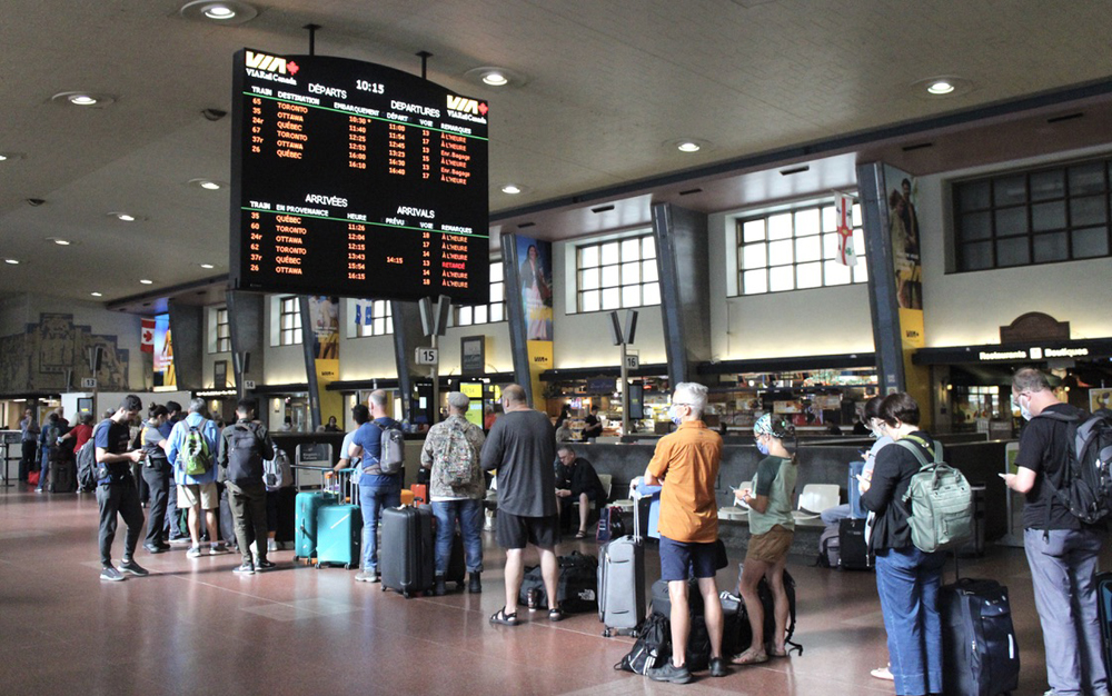 People standing in line at train station