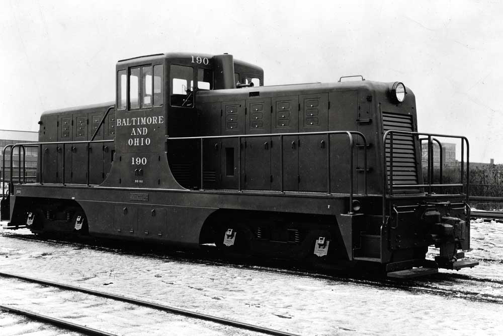Centercab diesel locomotive in rail yard in snow
