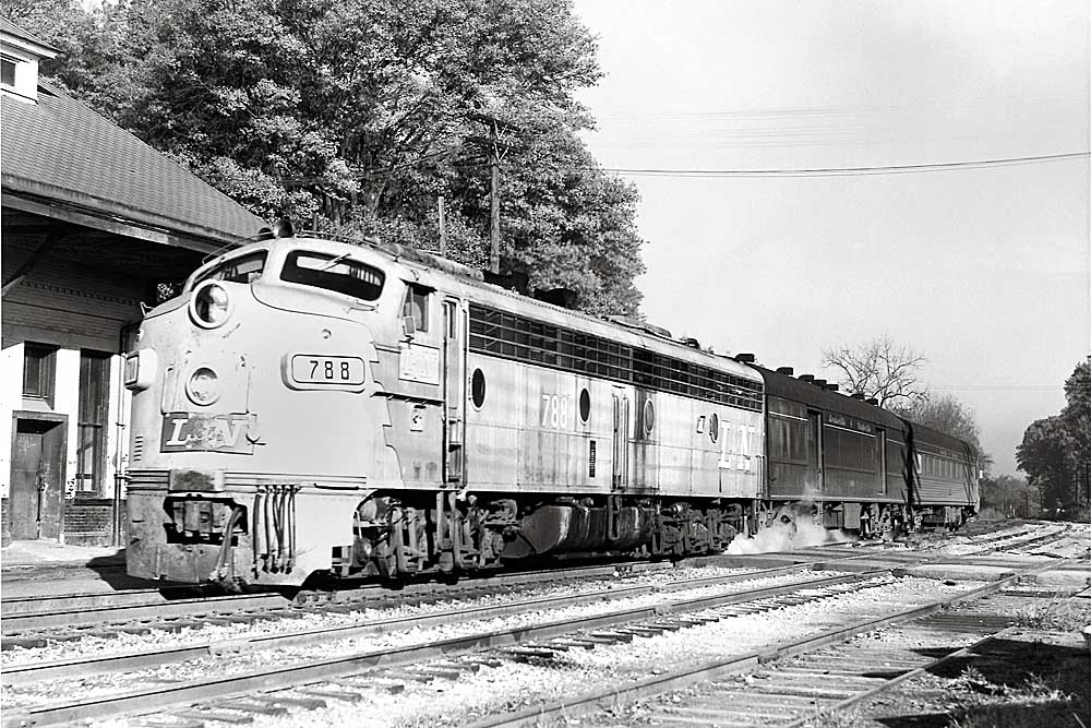 Streamlined diesel locomotive with passenger train at station