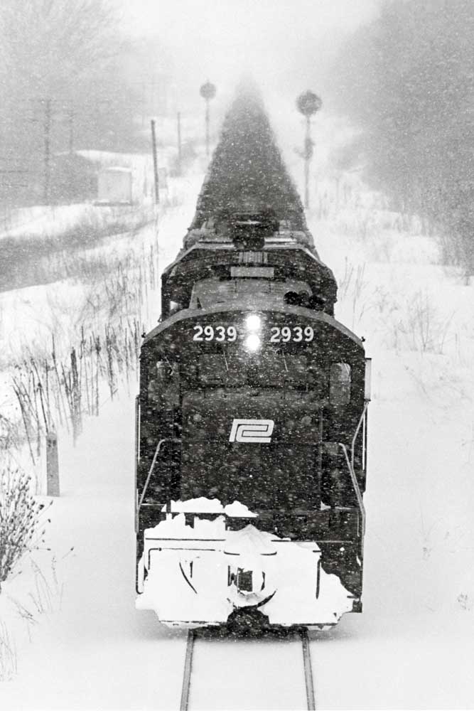 Front of Penn Central locomotives approaching camera in snow