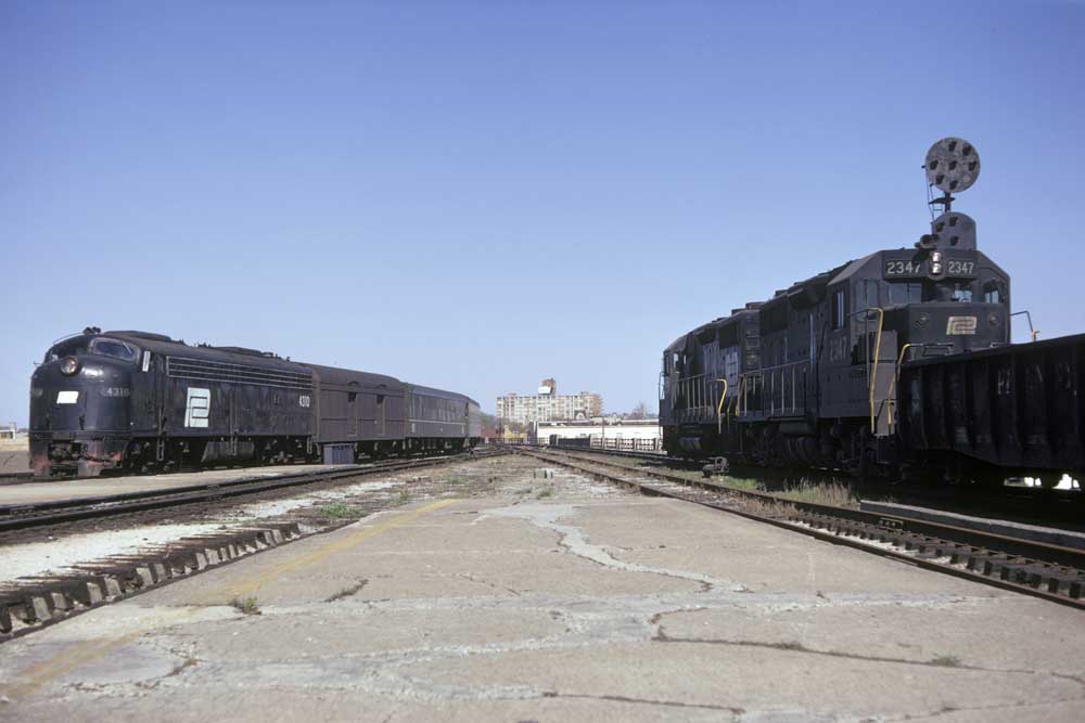 Passenger train at left meets freight train at right