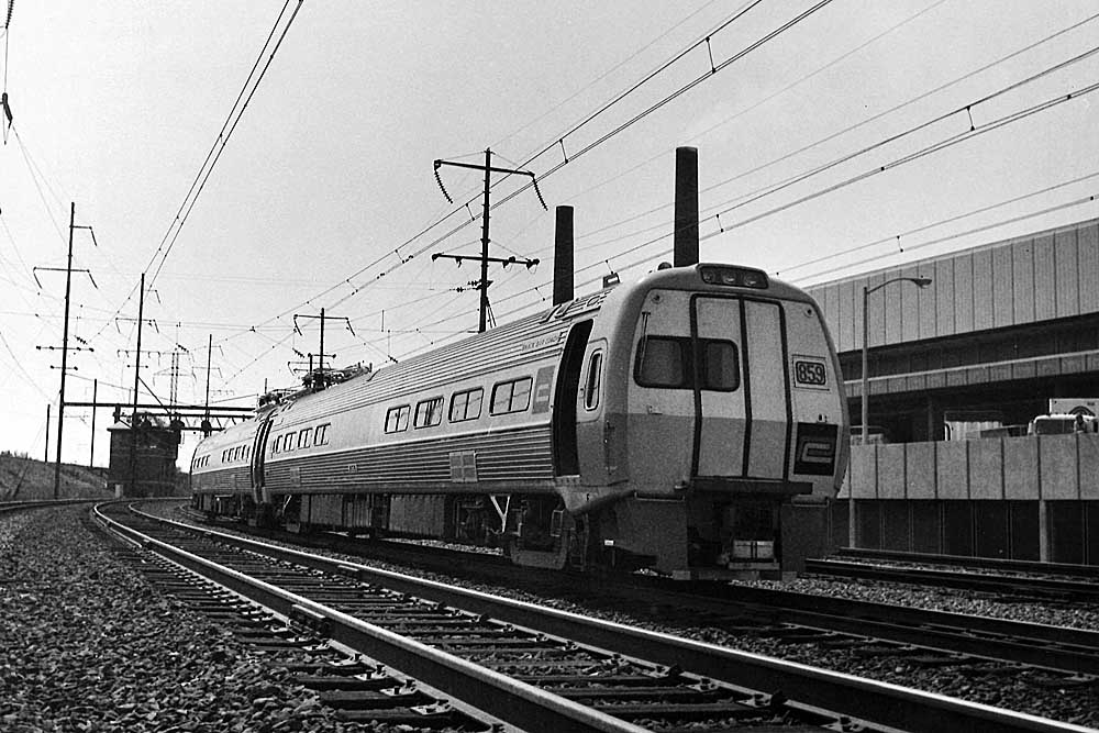 New stainless steel Penn Central passenger trains equipment on curve